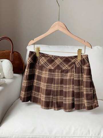 Brown and beige plaid pleated skirt on a hanger